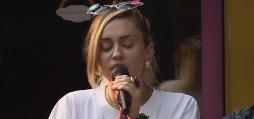 Miley Cyrus performing an emotional country-infused cover of Roberta Flack’s “The First Time Ever I Saw Your Face” at Rainbowland Studios in Malibu, wearing sunglasses and a casual t-shirt dress.